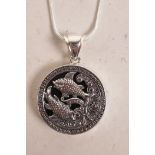 A sterling silver and onyx pendant necklace with Pisces star sign decoration, 1" diameter