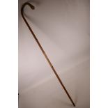 A Chinese bamboo walking stick with carved snake decoration, 35½" long