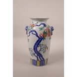 A Chinese polychrome porcelain vase with twin mask handles and fruiting pomegranate tree decoration,