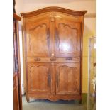 A good C18th French cherrywood armoire with domed chapeau de dame top, two cupboards with moulded