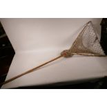 A C19th Hardy Bros folding landing net with long wood handle and frame with brass fittings, 48" long