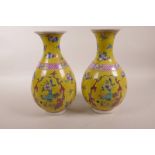 A pair of Chinese yellow ground porcelain pear shaped vases decorated in polychrome enamels
