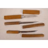 Three Japanese floating wood and steel fish knives, longest 10½"