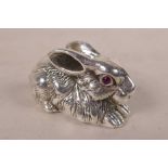 A novelty sterling silver rabbit with ruby set eyes, 2" long