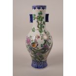 A Chinese polychrome porcelain vase with two lug handles, decorated with Asiatic birds and