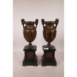 A pair of late C19th bronze and parcel gilt classical urns, mounted on polished slate pedestals, 15"
