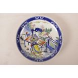 A Chinese wucai porcelain cabinet plate decorated with a woman and child playing in a garden, 9"