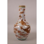 A Chinese polychrome porcelain bottle vase decorated with a red and gilt dragon chasing the