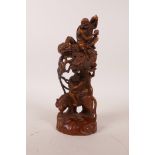 A Chinese boxwood carving depicting two Lohan riding a dragon and tiger, 7" high