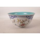 A Chinese blue and white porcelain bowl with polychrome decorative panels depicting birds amongst