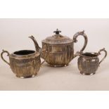 A C19th Regency style silver plated three piece tea set with ribbed and classical swag decoration