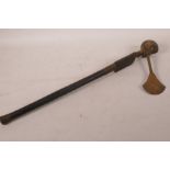 An Ethnic carved wood axe with figural decoration and woven wire banding, 19½" long