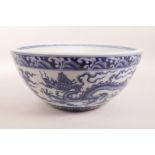 A large Chinese blue and white porcelain bowl decorated with dragons in flight, 6 character mark