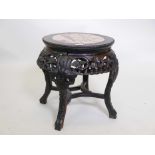 A late C19th Chinese hardwood low stand, with carved and pierced frieze, and inset marble top, 17" x
