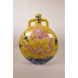 A large Chinese yellow ground moon flask with two handles decorated with a dragon chasing the