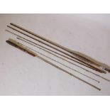Two vintage three section fly fishing rods, one wooden and one metal