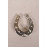 A large sterling silver horseshoe brooch, 2"