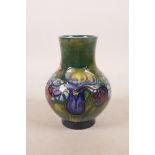 A Moorcroft pottery green ground flower vase, 5" high
