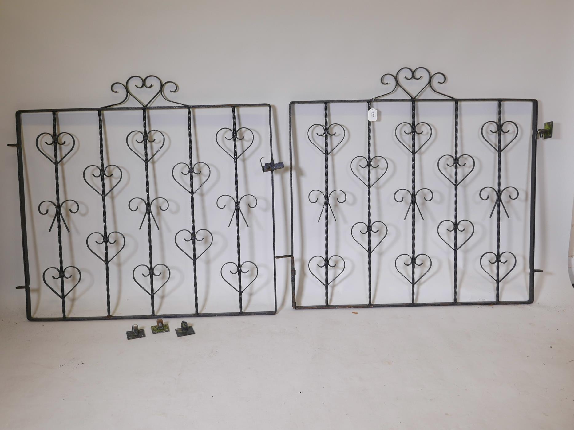 A pair of wrought iron gates, 89" wide including hinges, 30" x 24" diameter