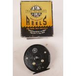 A vintage J.W. Young & Sons Beaudex salmon fishing reel, 4" diameter, unused and in original box