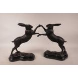 A bronzed metal figure of boxing hares, 11½" high