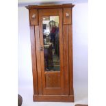 A Harris Lebus oak hall cupboard/wardrobe with pewter and exotic wood inlaid decoration, 37" x 18" x