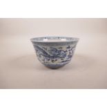 A Chinese blue and white porcelain rice bowl decorated with dragons chasing the flaming pearl,