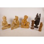 Three Balinese carved wood figures of musicians, together with three other carved wood figures,