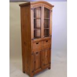 A fruitwood, arched top kitchen cupboard with two glazed doors, 31½" x 18", 75" high