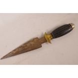 An ethnic ceremonial dagger with engraved blade, carved wood handle and brass fittings, 13" long