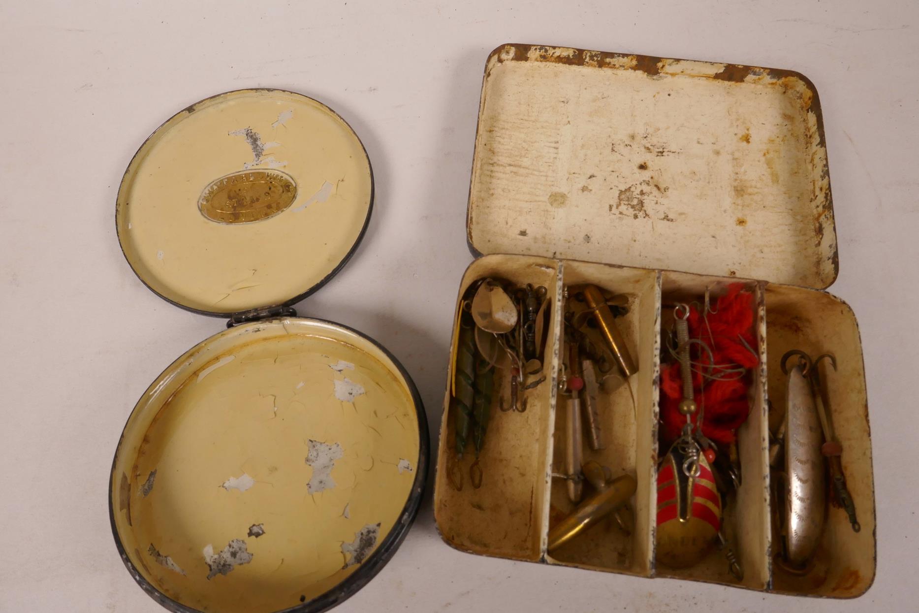 A small vintage lure box, 4¼" x 3" x 1", containing various lures, together with a round Chas Farlow