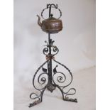 An early C20th wrought iron spirit kettle stand, 31" high