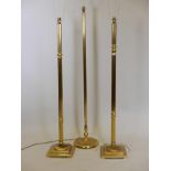A pair of brass standard lamps, 49" high, and another