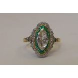A fine Art Deco emerald and diamond panel ring, the central marquise cut diamond surrounded by