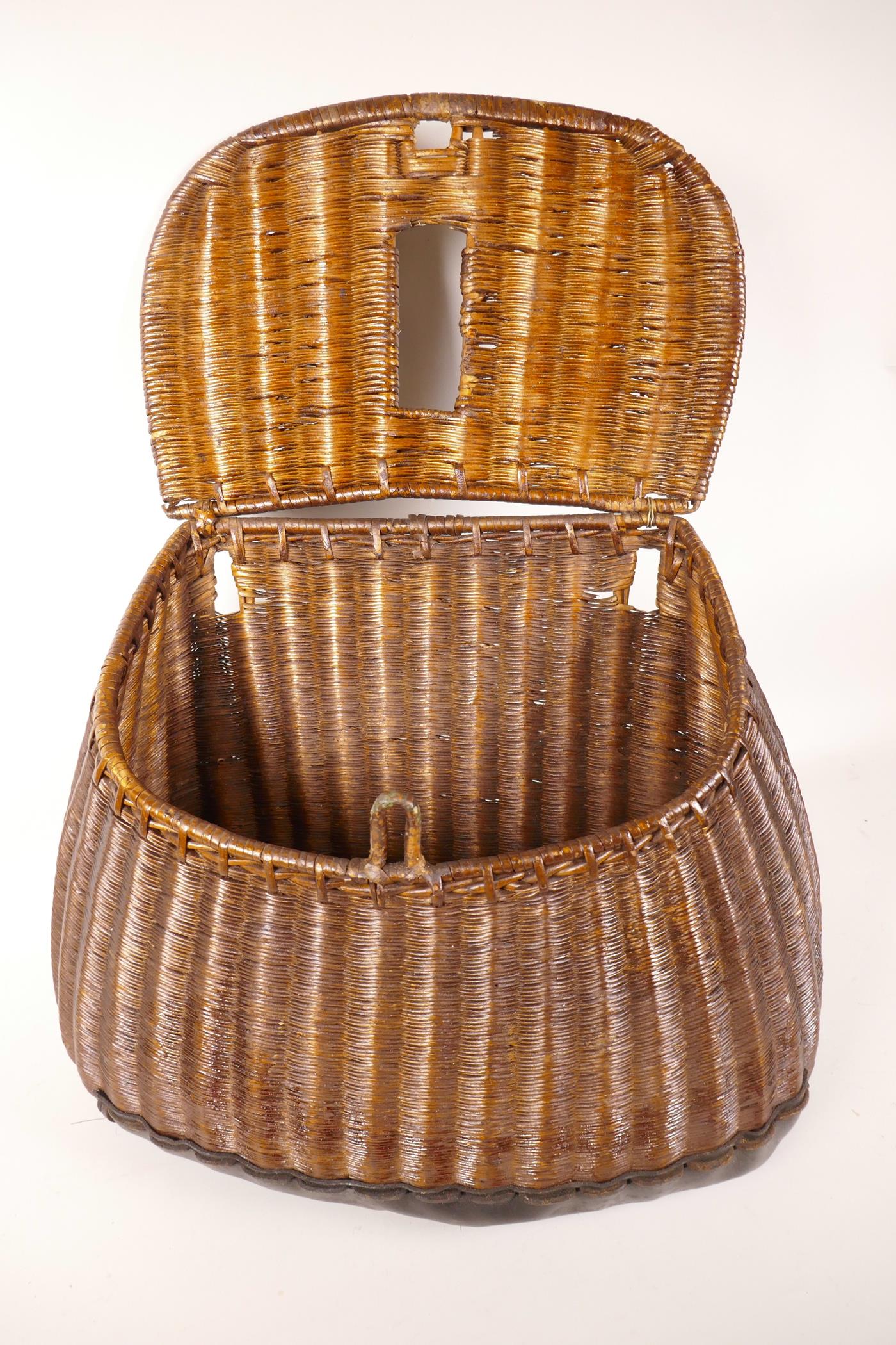 An antique woven fishing basket (creel), 13" wide