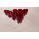 A set of ten ruby glass long stem sherry glasses with clear twist stems and feet, 5¾" high, one chip