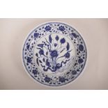 A Chinese blue and white porcelain charger decorated with lotus flowers, 6 character mark to rim,
