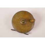 A vintage brass and aluminium plate wind fishing reel, 3" diameter