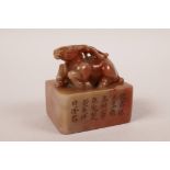 A Chinese soapstone seal with a carved knop in the form of a stag, boxed, 2½" x 1½"