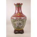 A Chinese polychrome porcelain reticulated vase with decorative landscape panels to body and
