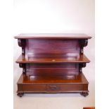 A Vicotorian mahogany three tier buffet with scrolled supports, single frieze drawer, and