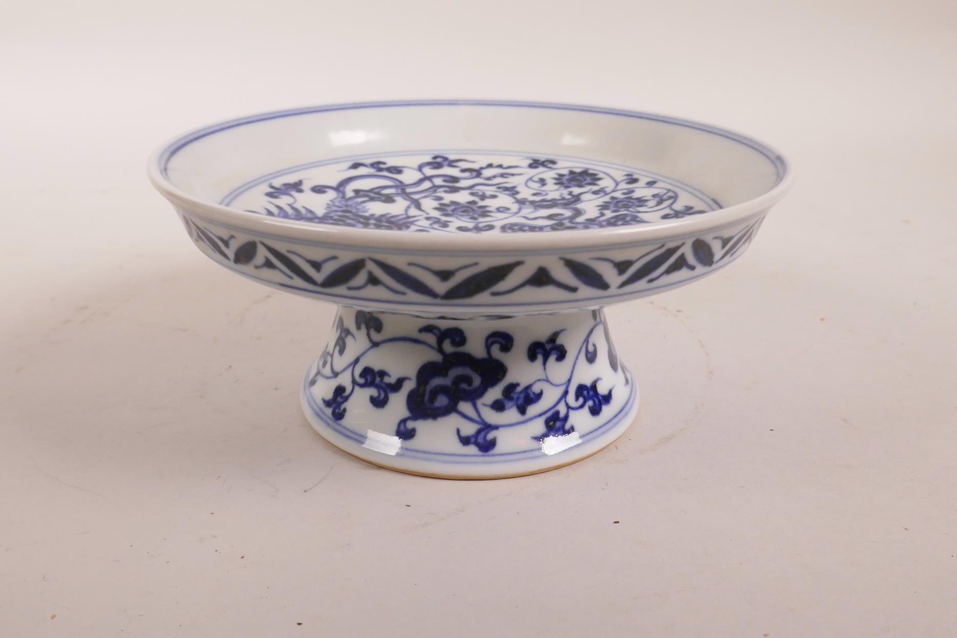 A Chinese blue and white stem dish with scrolling lotus flower and phoenix decoration, 6 character