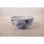 A Chinese blue and white porcelain bowl decorated with dragons chasing the flaming pearl, 6