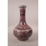 A Chinese red and black porcelain bottle vase decorated with mythical creatures, 6 character mark to