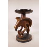 An African carved wood stool in the form of an eagle catching a fish, 13½" high