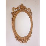 A large C19th giltwood and composition wall mirror with laurel leaf and swag decoration, 30" x 46"