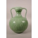 A Chinese green glazed porcelain garlic head flask with two handles and underglaze lotus flower