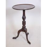 A Georgian Cuban mahogany dish top lamp/wine table, raised on a turned and carved column and