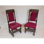 A pair of C17th/18th oak high back side chairs with carved coronets to back rail and stretcher,