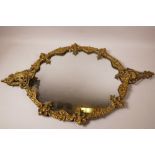 An ornate cast brass framed oval wall mirror, 17" x 28"